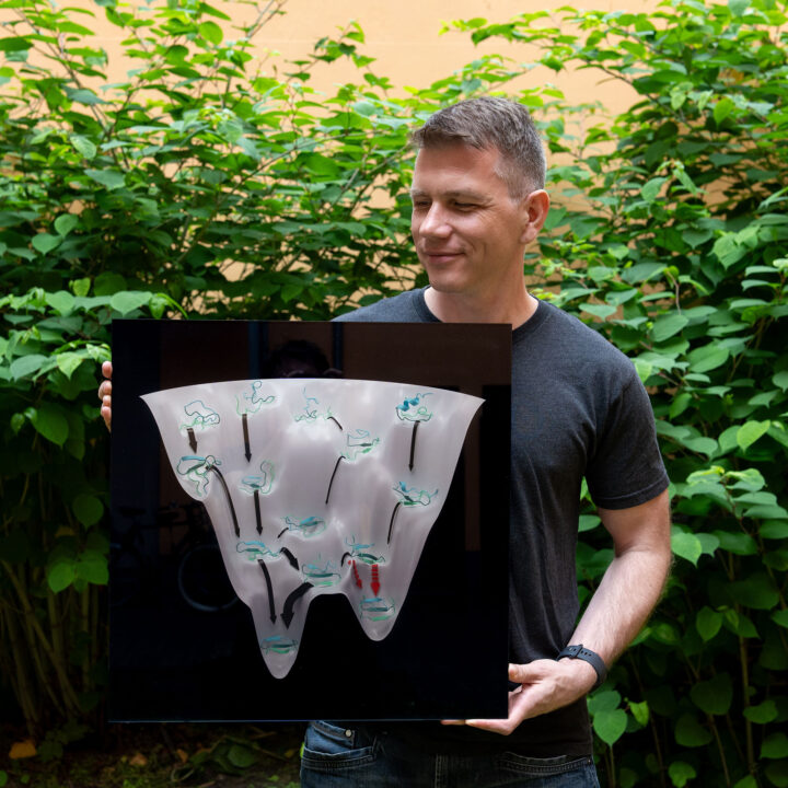 Thomas holding print of folding funnel illustration