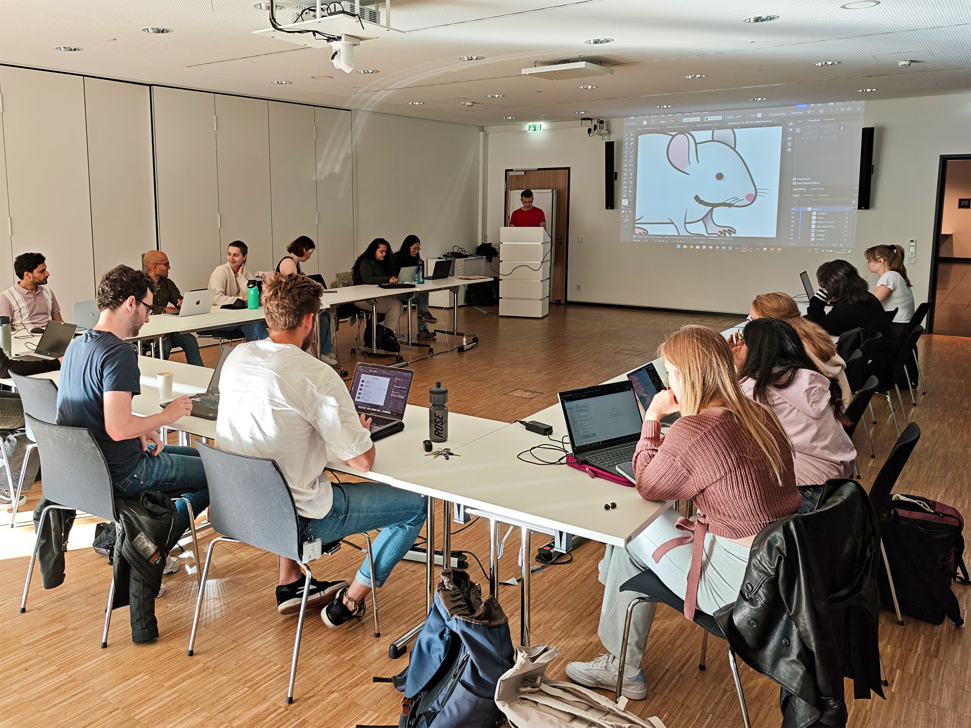 Workshop participants working on scientific illustrations on their laptops
